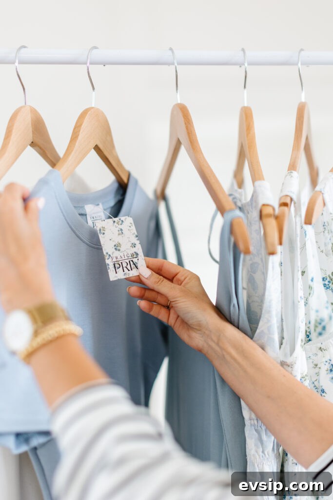 hand holding a dress with a tag reading: The Fraîche x PRIV Summer Collection