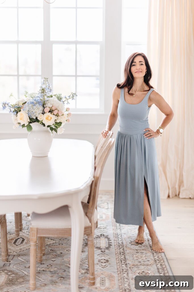 Tori wearing a midi length blue dress in her home from The Fraîche x PRIV Summer Collection