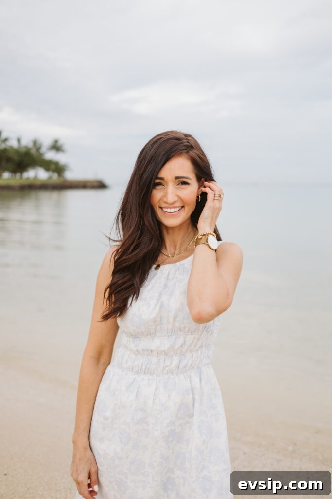 Tori on the beach in Hawaii in a short white and blue dress from The Fraîche x PRIV Summer Collection