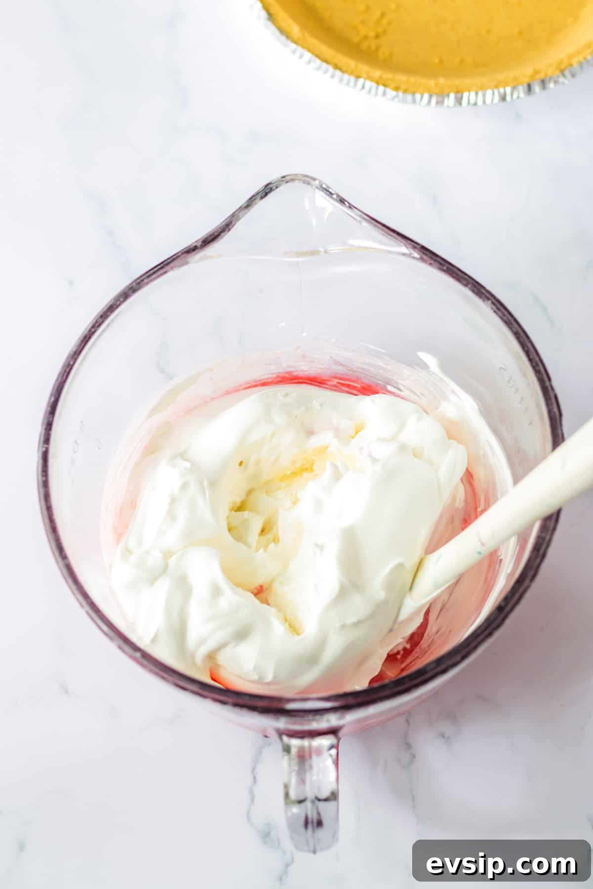 Mixing bowl with Cool Whip added to the kool aid mixture.