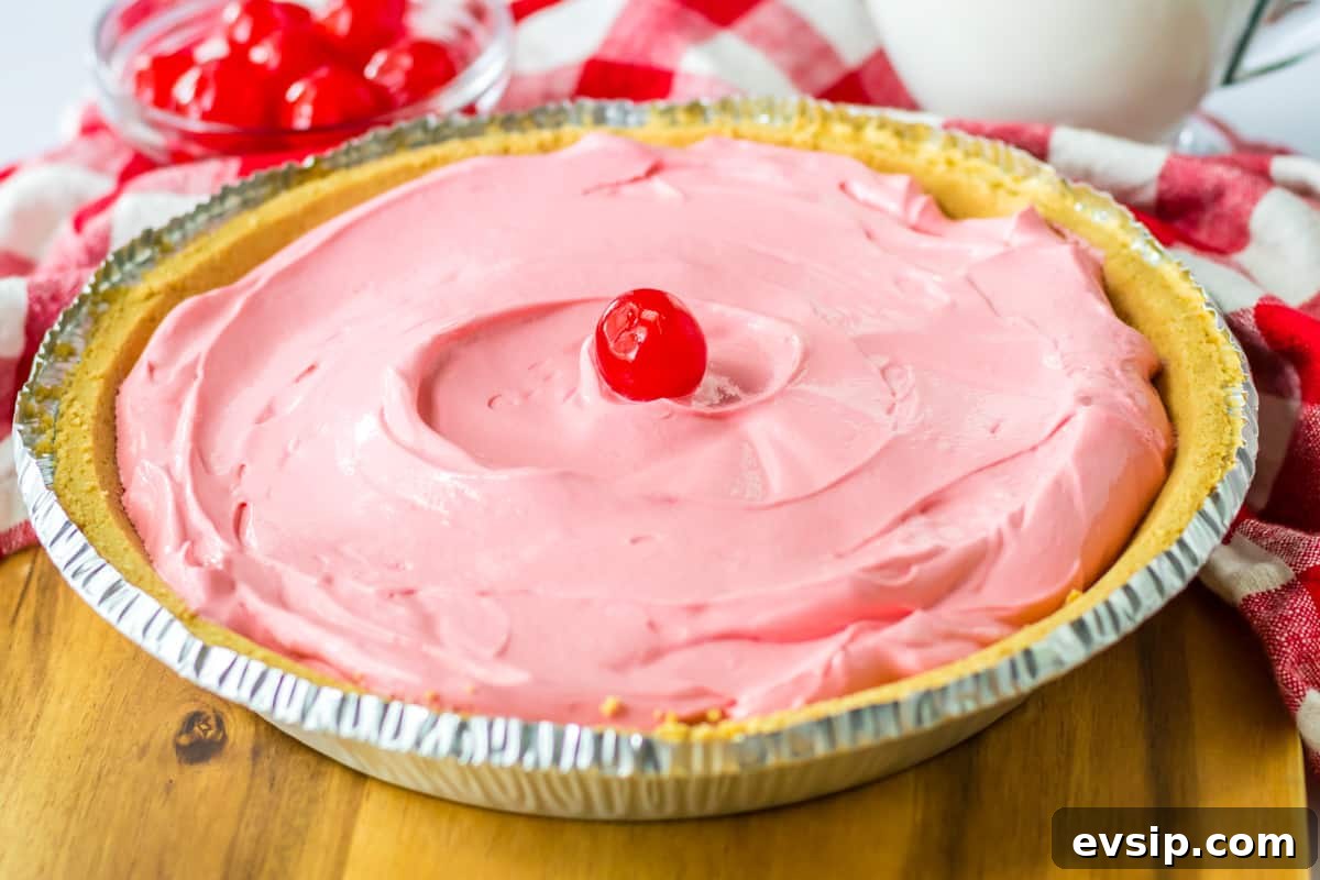 Cherry kool aid pie with cool whip in a graham cracker crust.