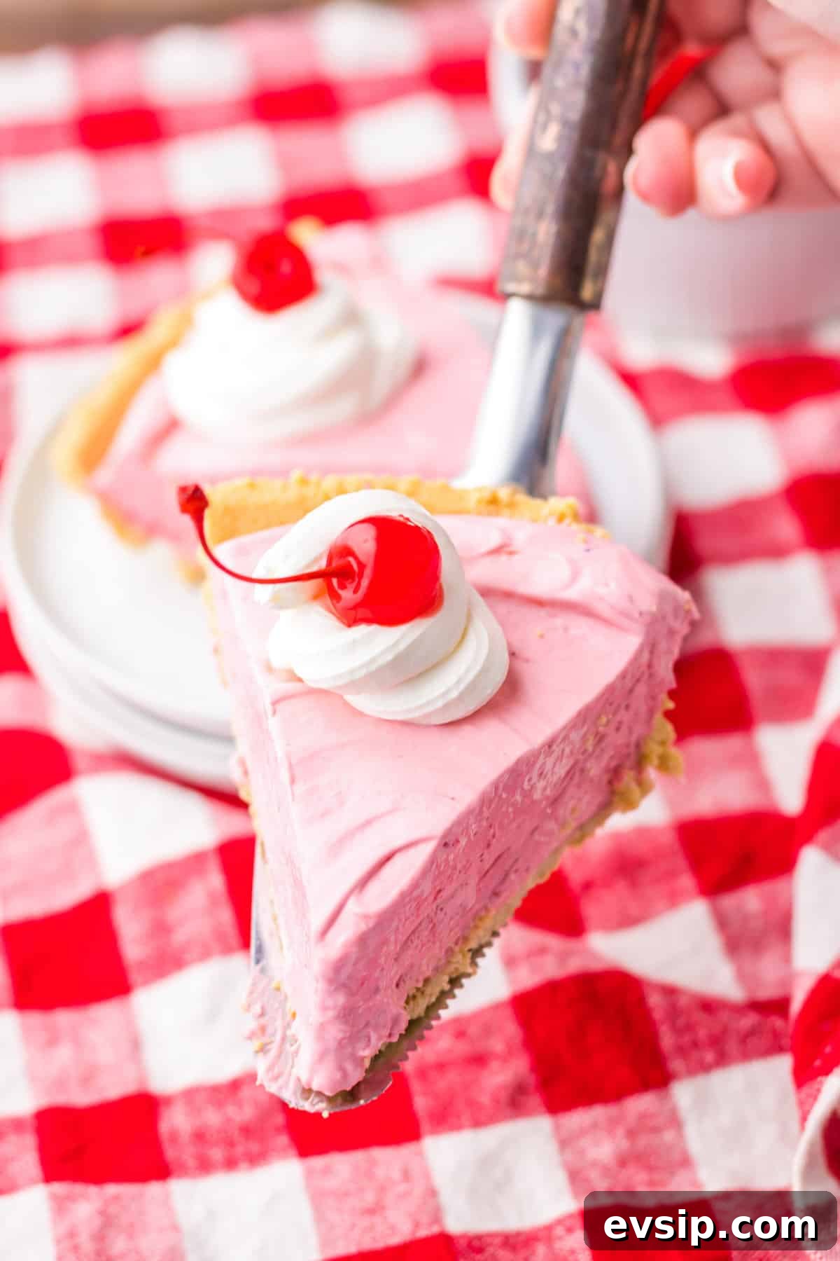 Slice of no bake kool aid pie on cake server.