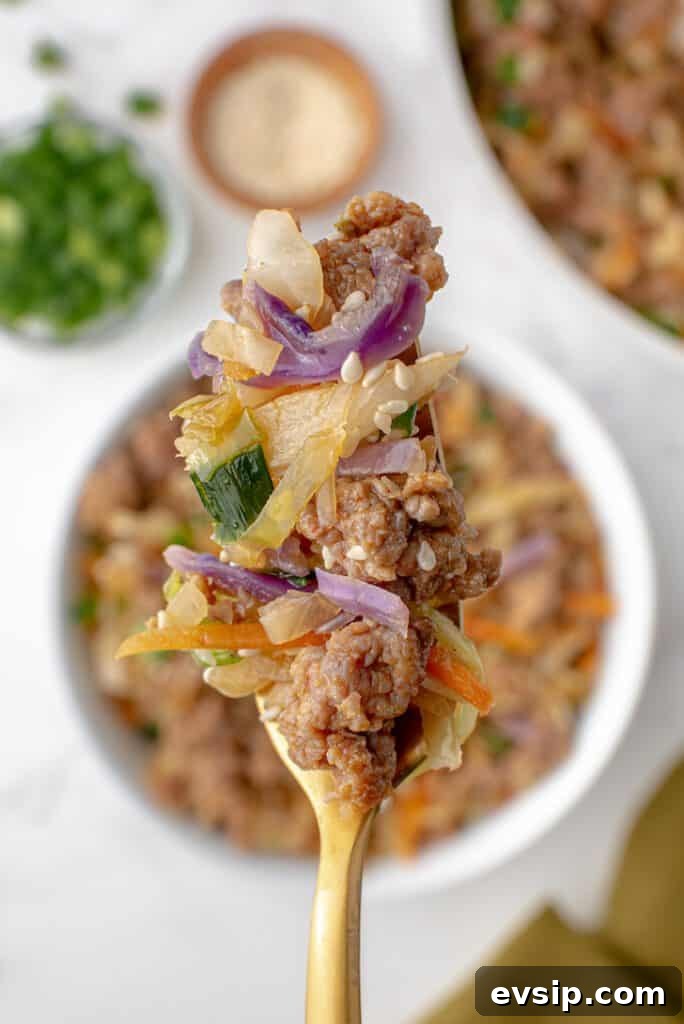 Ground Pork Egg Roll Bowl — One-Pan Dinner Recipe 6 A forkful of colorful unstuffed egg roll.