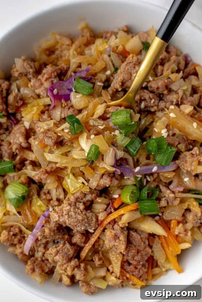 Ground Pork Egg Roll Bowl — One-Pan Dinner Recipe 7 Cooked cabbage, carrots, green onions, sesame seeds and soy sauce with ground pork.