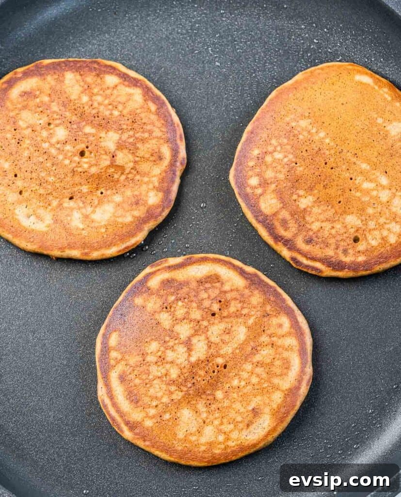Cooking pancakes on a griddle.