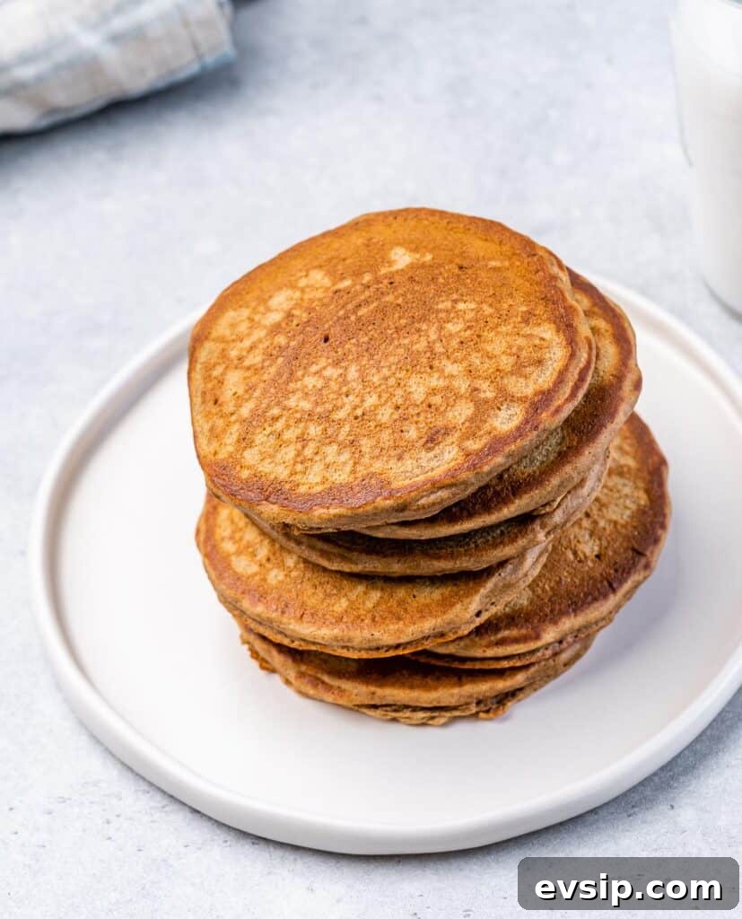 Stack of pancakes on a white plate.