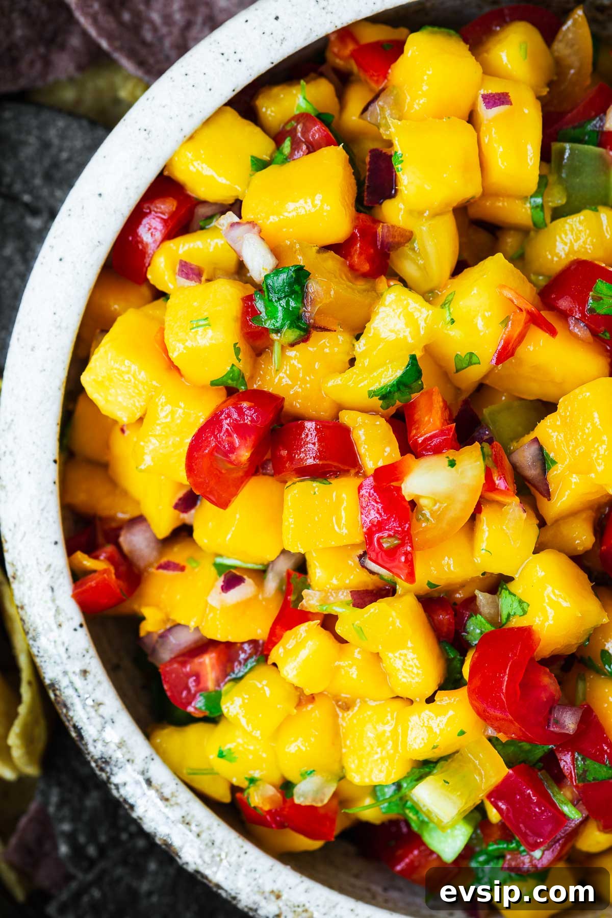 Mango Habanero Salsa Recipe — Fresh Homemade Fruit & Chili Salsa 8 A top-down close-up view of a bowl of fresh mango habanero salsa.