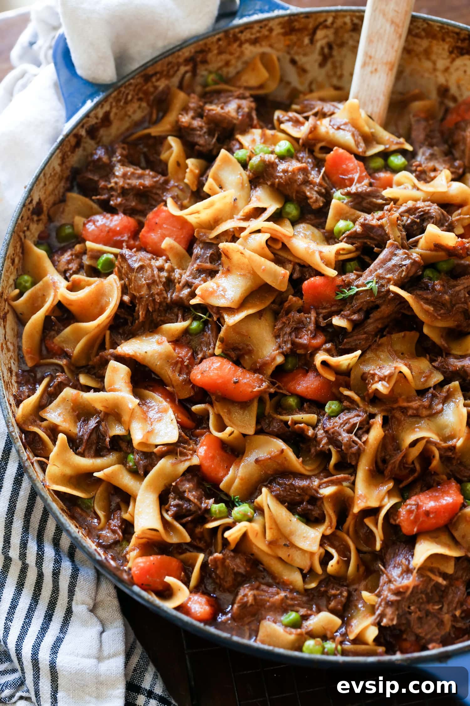Savory Beef and Noodle Stir-Fry Recipe for Weeknight Dinners 2 Beef and noodles cooked in a dish with carrots and peas