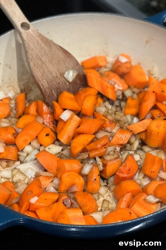Savory Beef and Noodle Stir-Fry Recipe for Weeknight Dinners 4 carrots and onions cooking in a dish