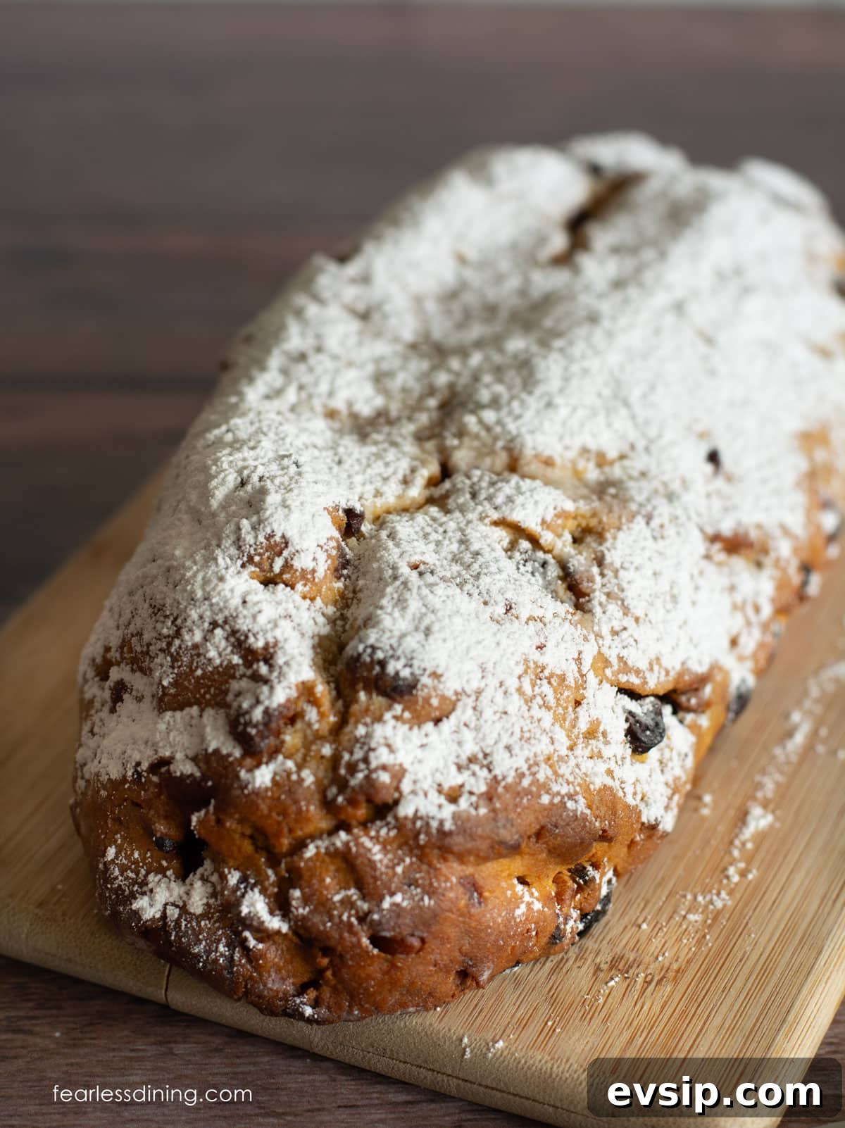 Light and Fluffy Gluten-Free Stollen Recipe for Holidays 2 An uncut loaf of gluten free stollen dusted in powdered sugar.