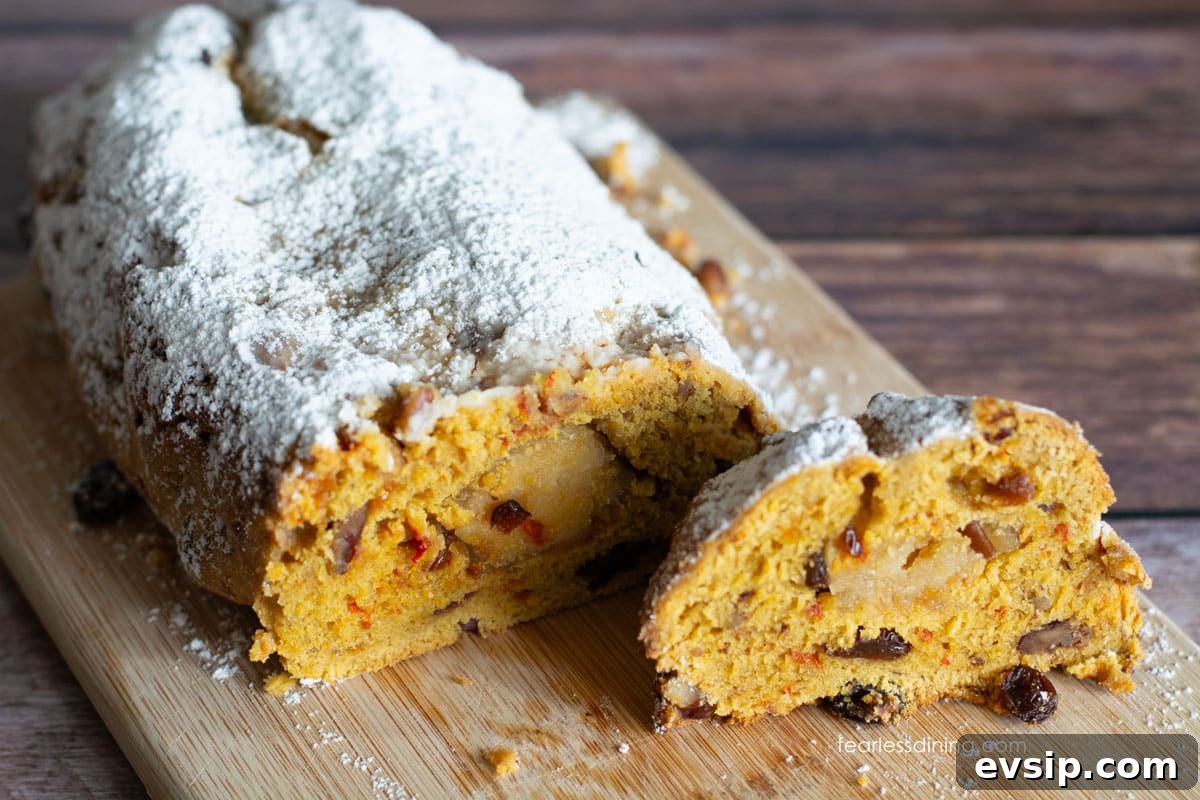 Light and Fluffy Gluten-Free Stollen Recipe for Holidays 5 Sliced stollen on a wooden cutting board.