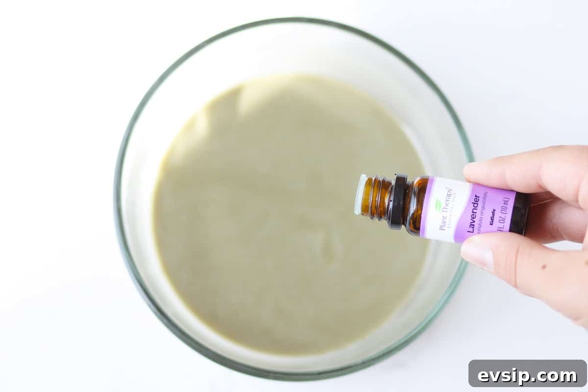 lavender essential oil being added to a bowl of anti-itch cream
