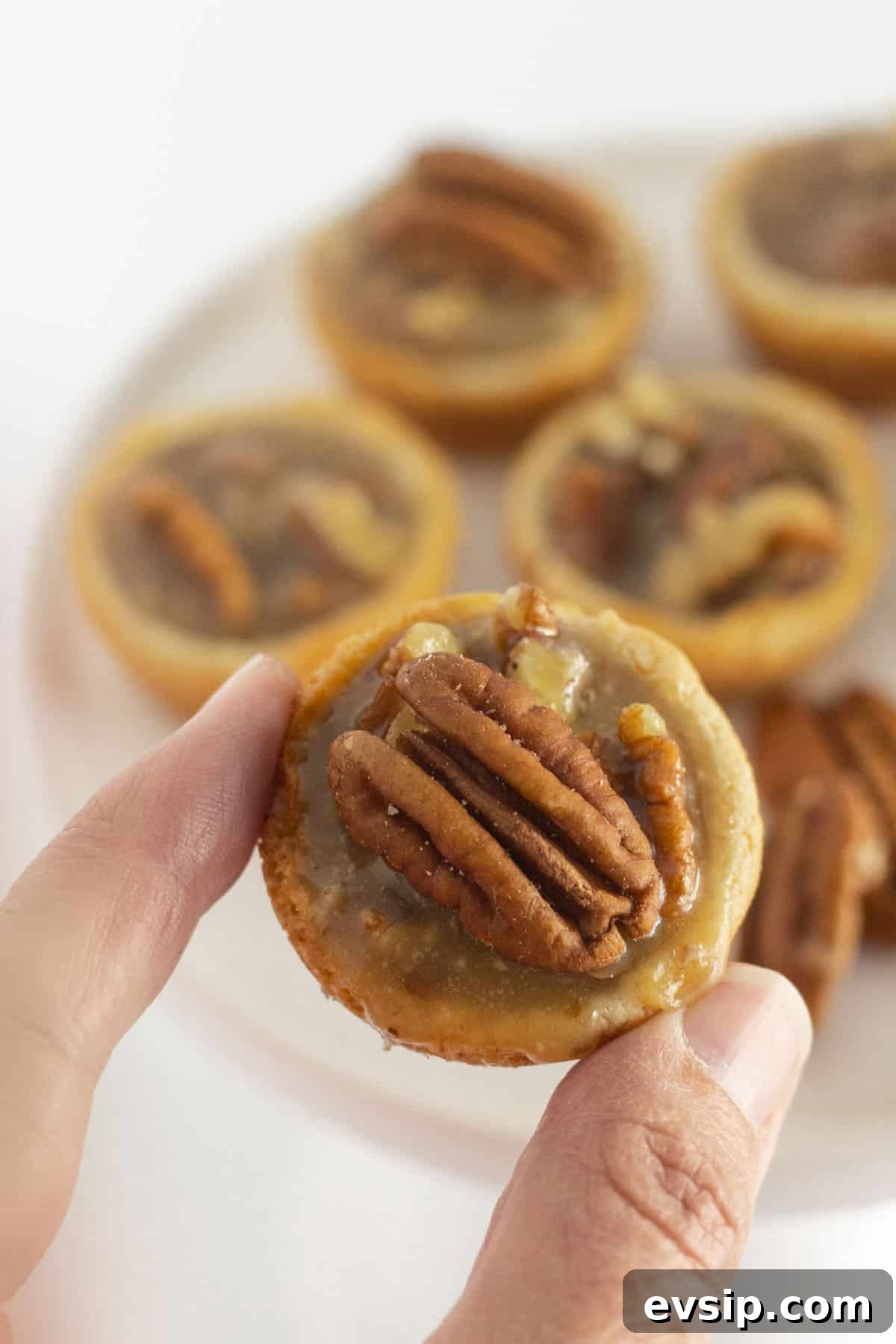 Pecan Pie Cookie Recipe: Chewy, Gooey Holiday Treat 7 Picking up and eating a mini pecan pie cookie.