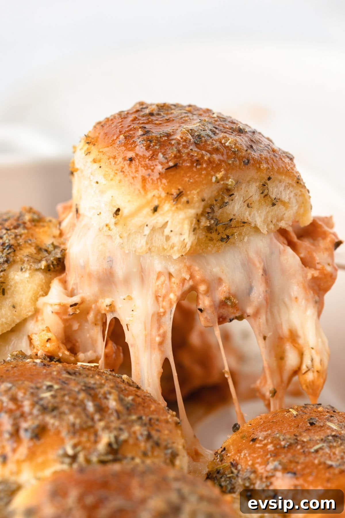 Creamy, melty chicken parmesan with bubbling cheese and crispy herbs on top.