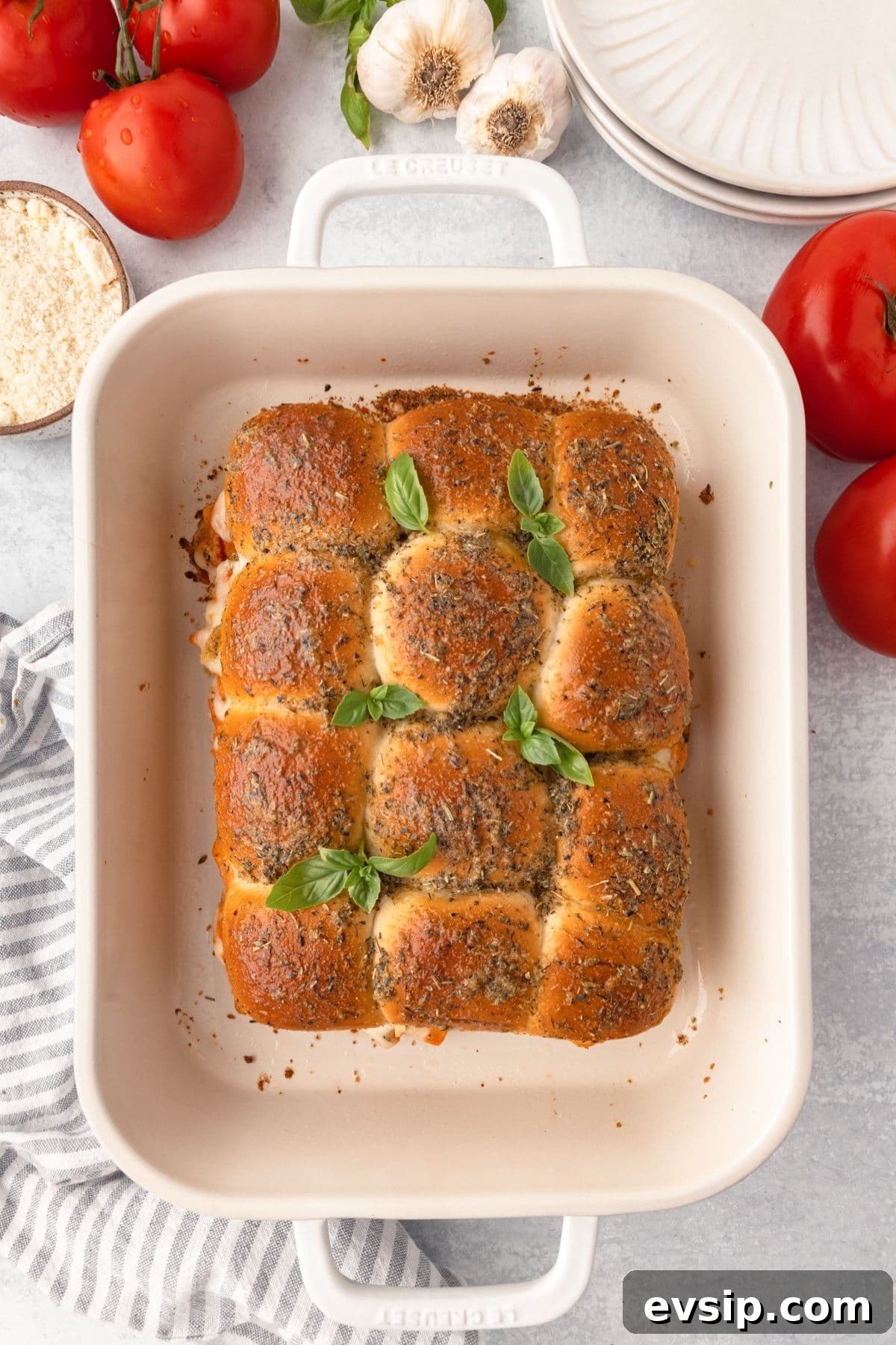 Roast chicken with herbs in a white baking dish.