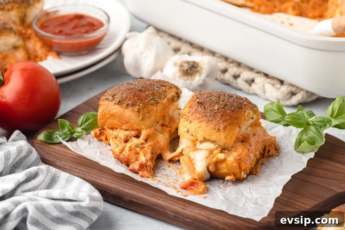 Cheesy pizza stuffed garlic bread, golden and crispy on a wooden board.