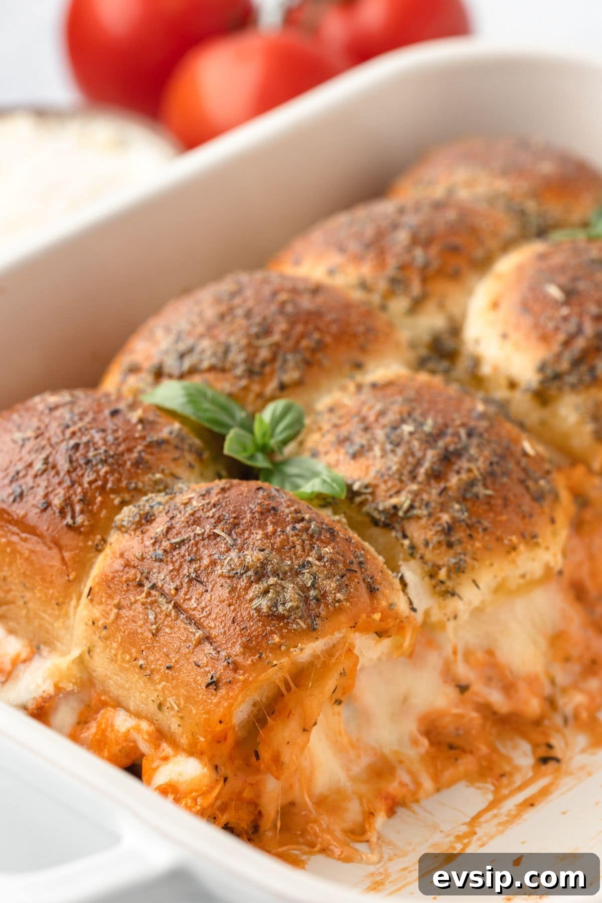 Baked garlic herb chicken thighs in cheesy tomato sauce with melted cheese and fresh basil.