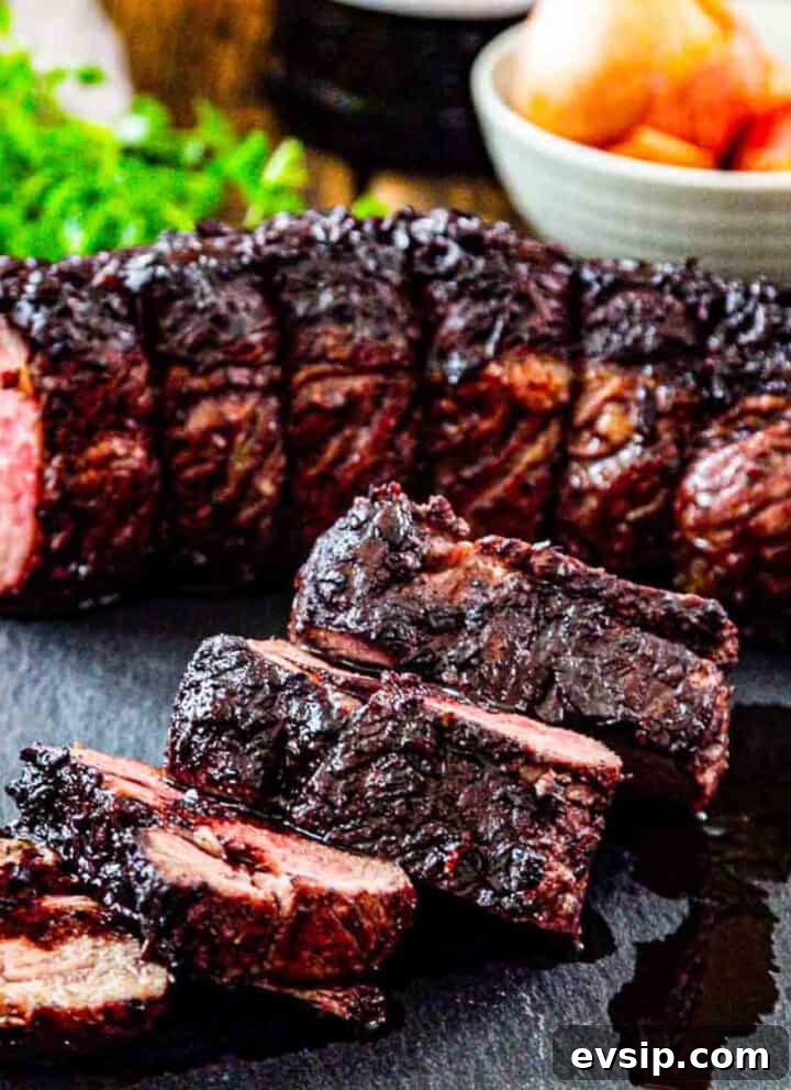 Thick sliced roast beef on a cutting board with pan juices and ingredients in the background.