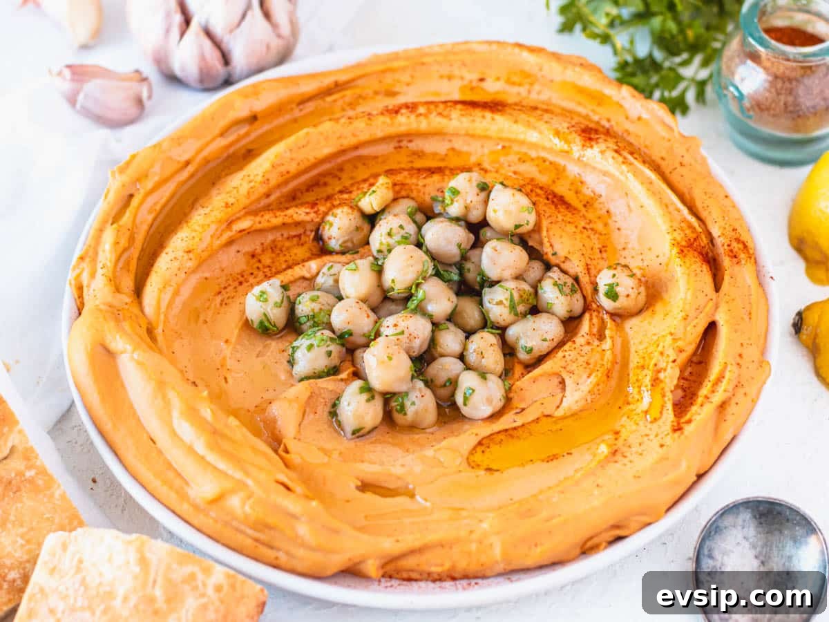 roasted pepper hummus with chickpeas in the middle