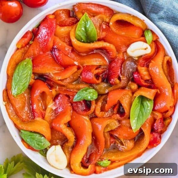 Roasted peppers marinated in a bowl.