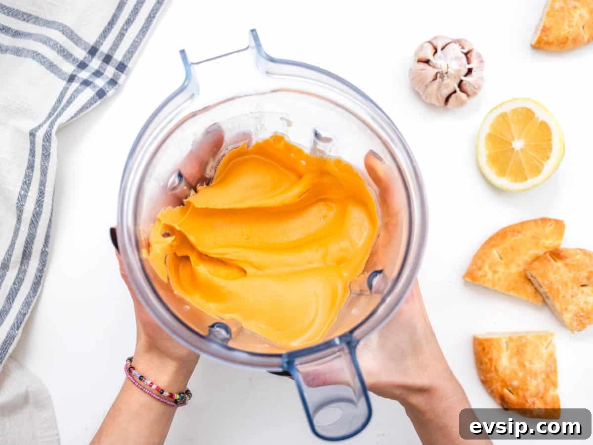 roasted pepper hummus after blending in a blender with two hands