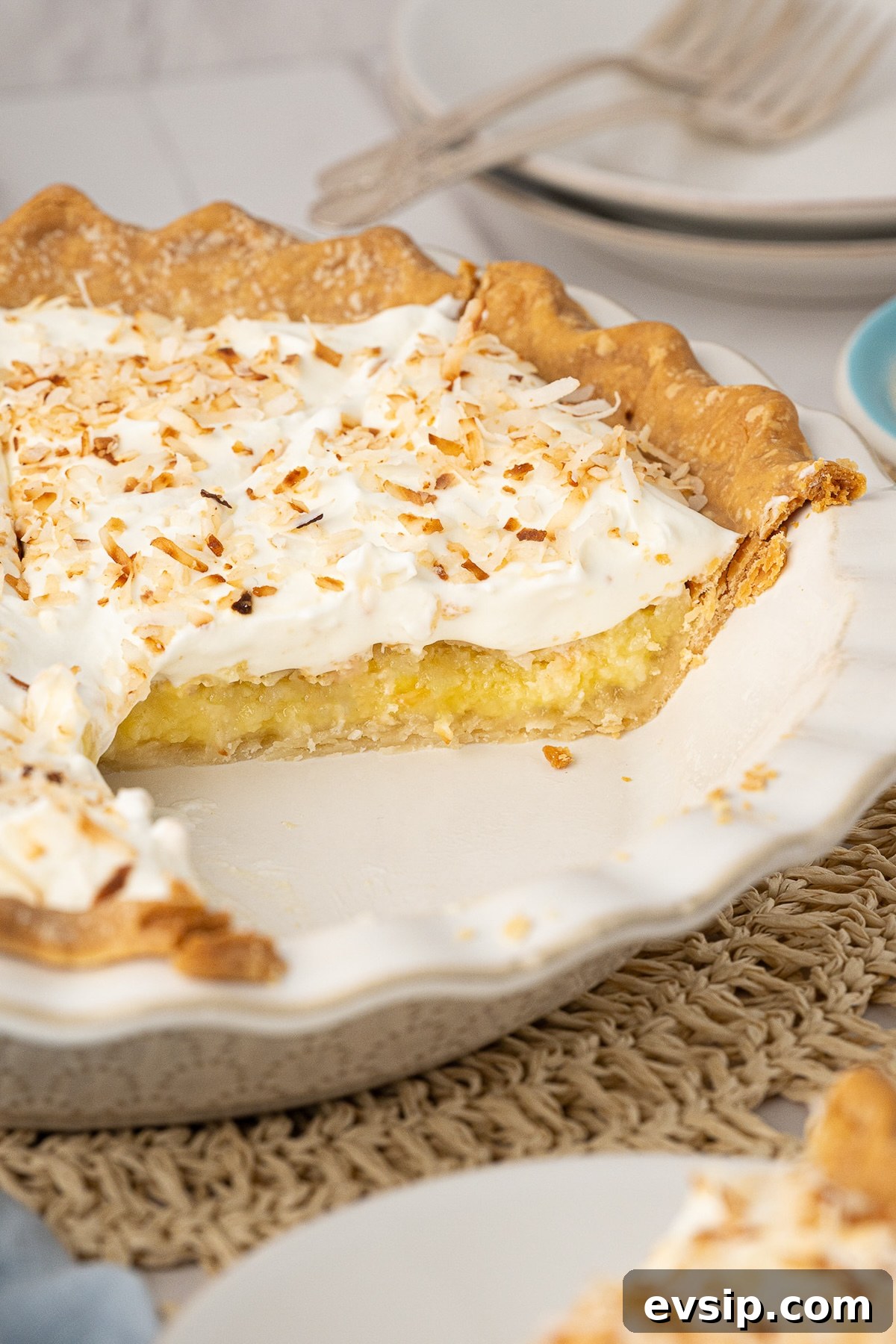 A side shot showing the coconut custard pie filling, which is a rich yellow color with visible coconut flakes.