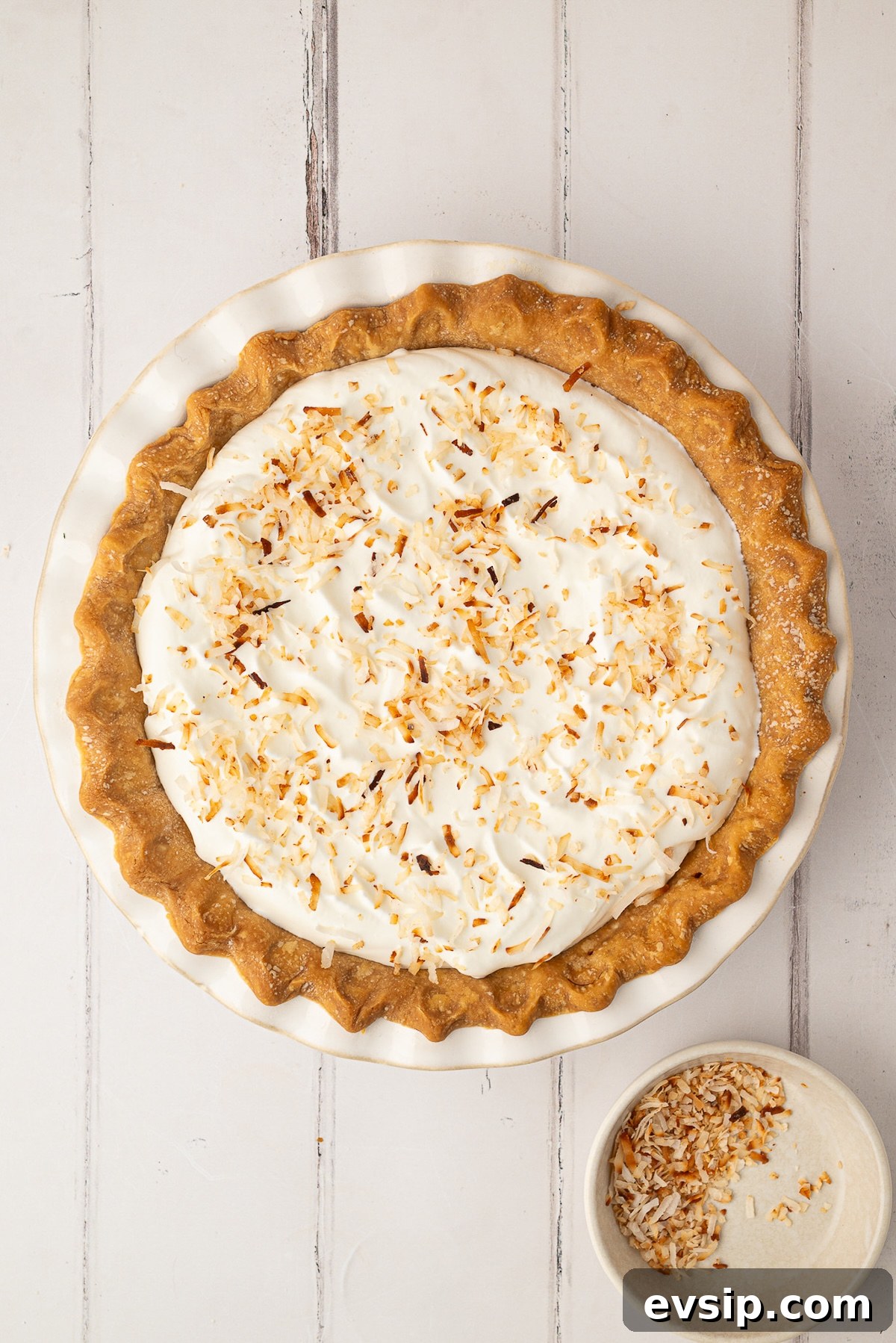 Topping the pie with toasted coconut.