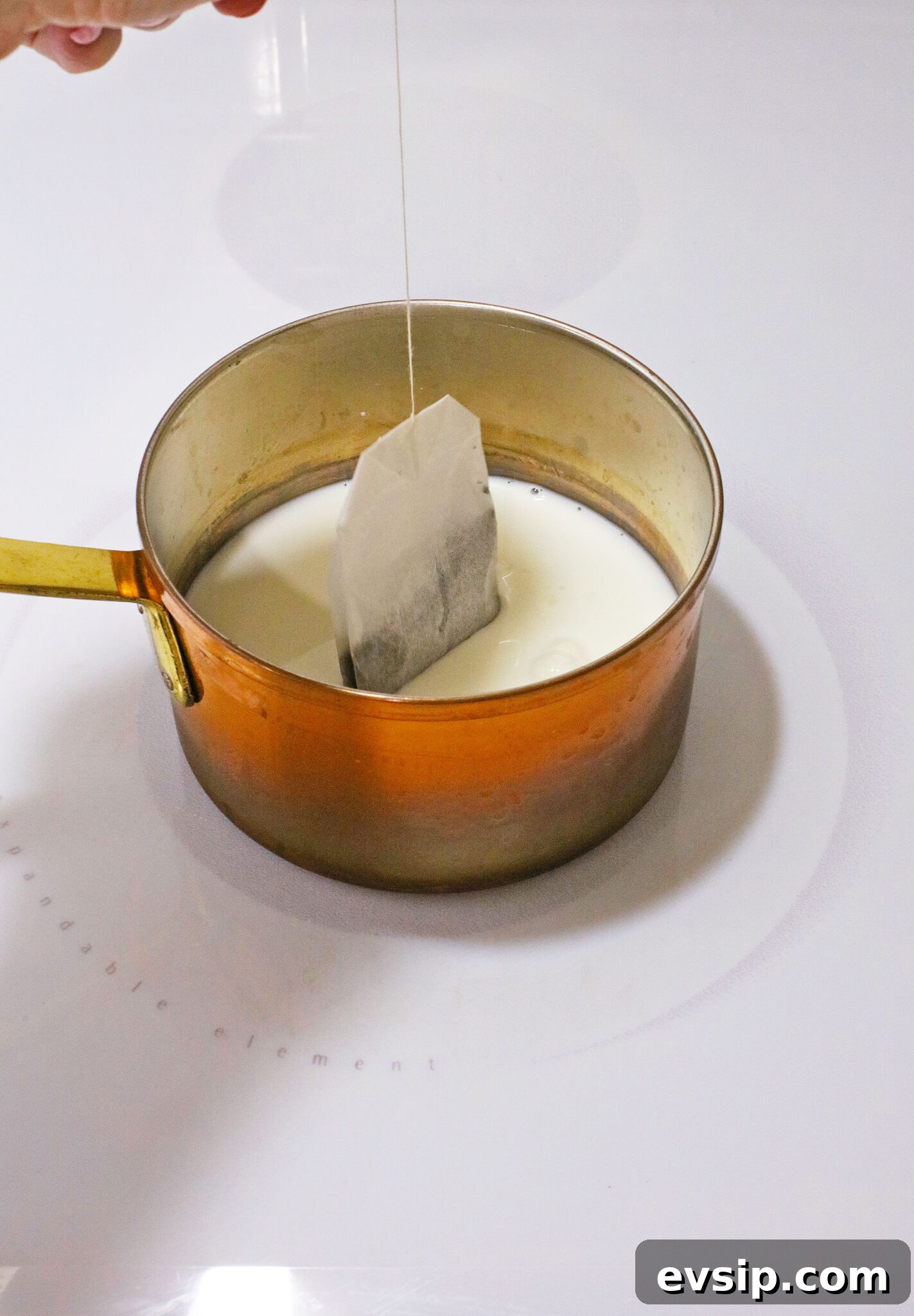 steeping black tea bags in milk