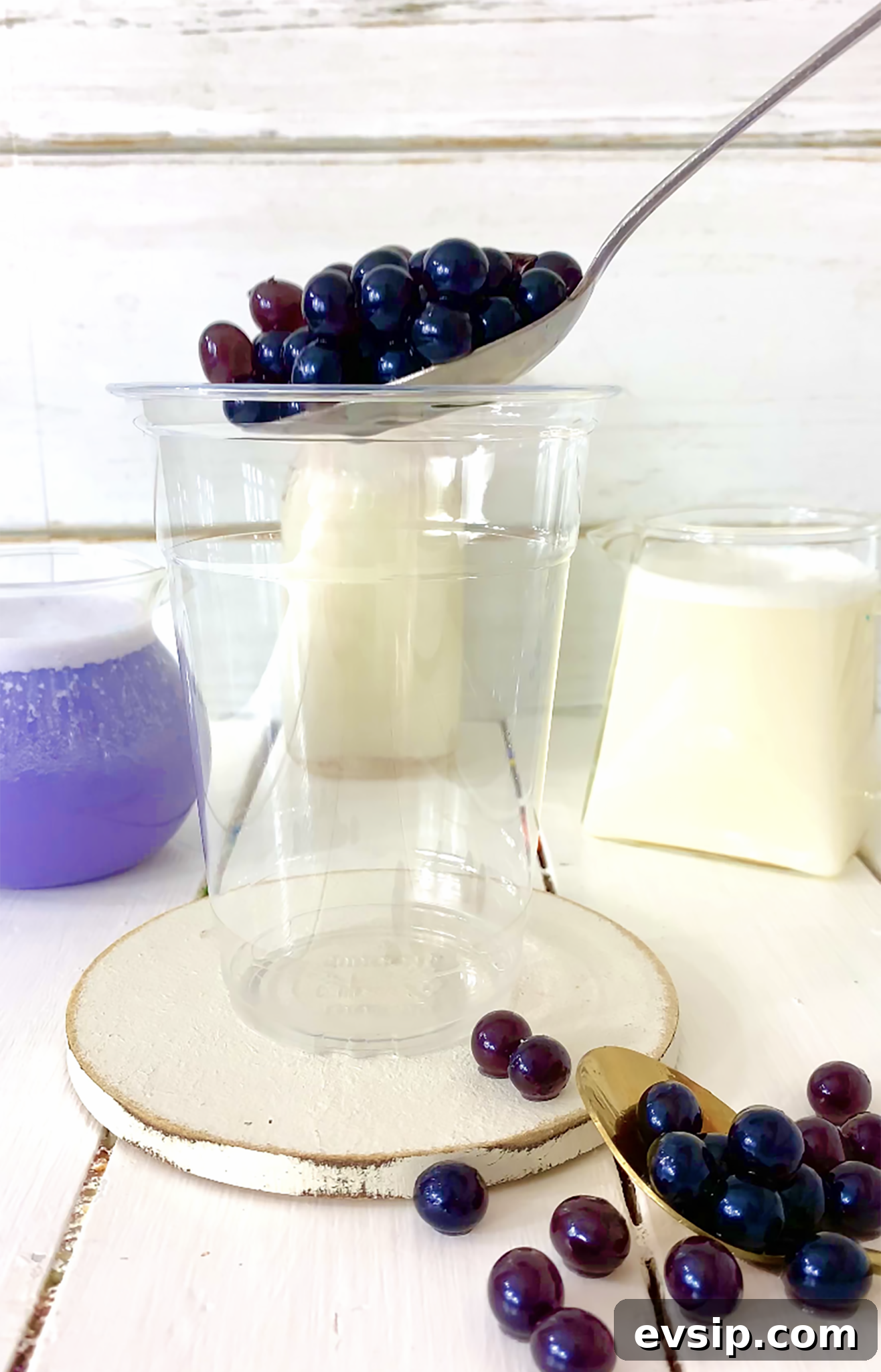 adding blueberry boba to glass