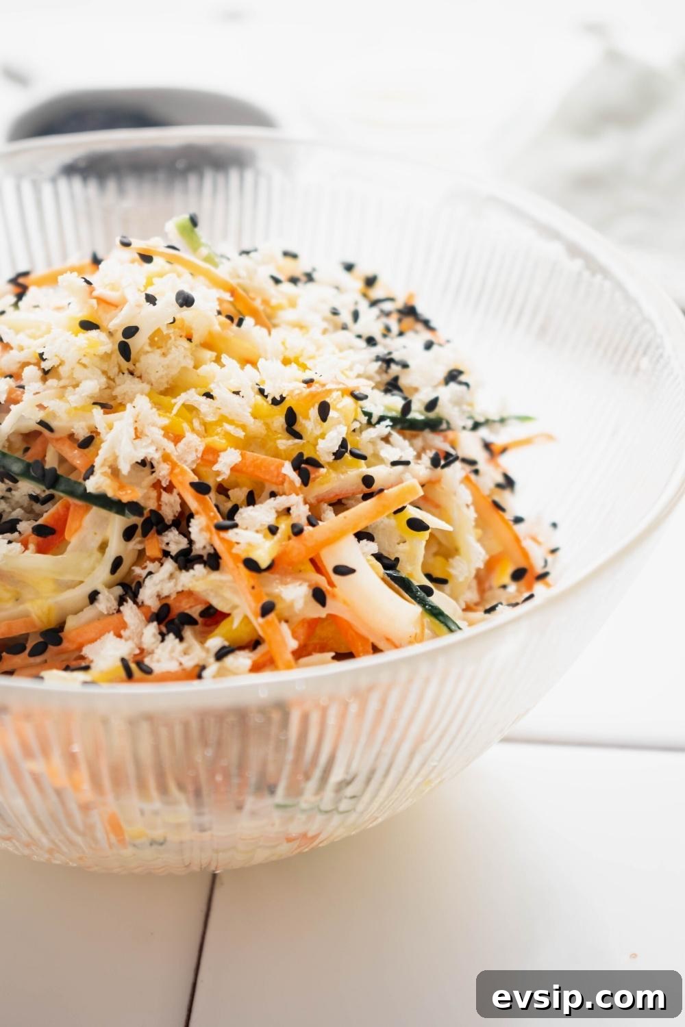Part of a glass bowl that has kani salad in it.