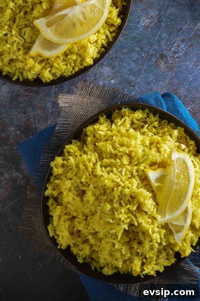 Overhead view of two bowls of yellow lemon rice