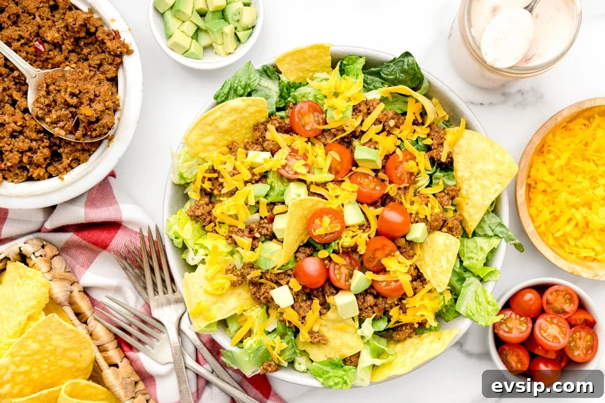 Homemade taco seasoning is simple, made with ingredients that are usually on hand. It gives a delicious flavor to any recipe!! Taco salad topped with tomatoes and cheese.