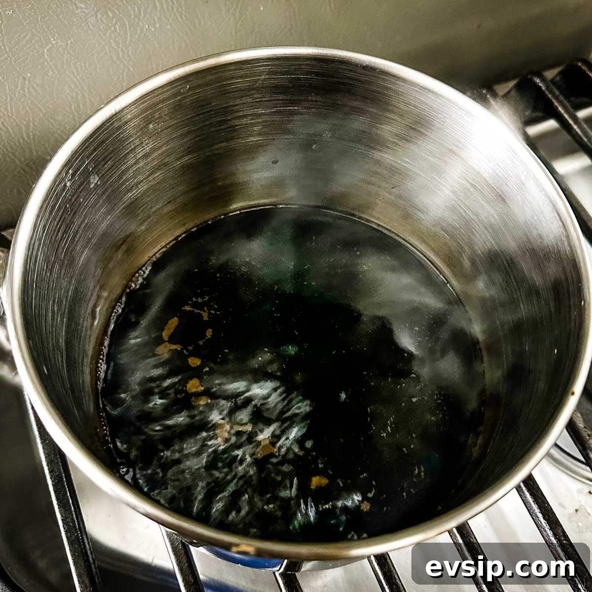 How to Make a Rich Balsamic Reduction for Glazes and Drizzles 4 Balsamic vinegar reduces in a stainless steel pot.