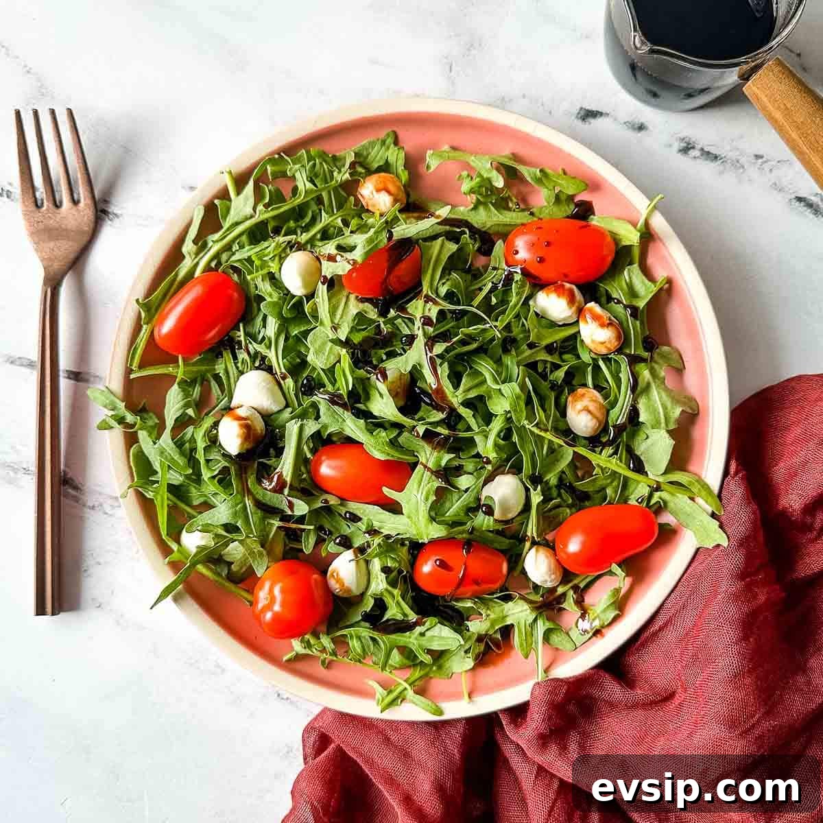 How to Make a Rich Balsamic Reduction for Glazes and Drizzles 5 Balsamic reduction is shown drizzled over a caprese salad with arugula.