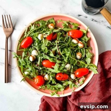 How to Make a Rich Balsamic Reduction for Glazes and Drizzles 6 Balsamic reduction is shown drizzled over a caprese salad with arugula.