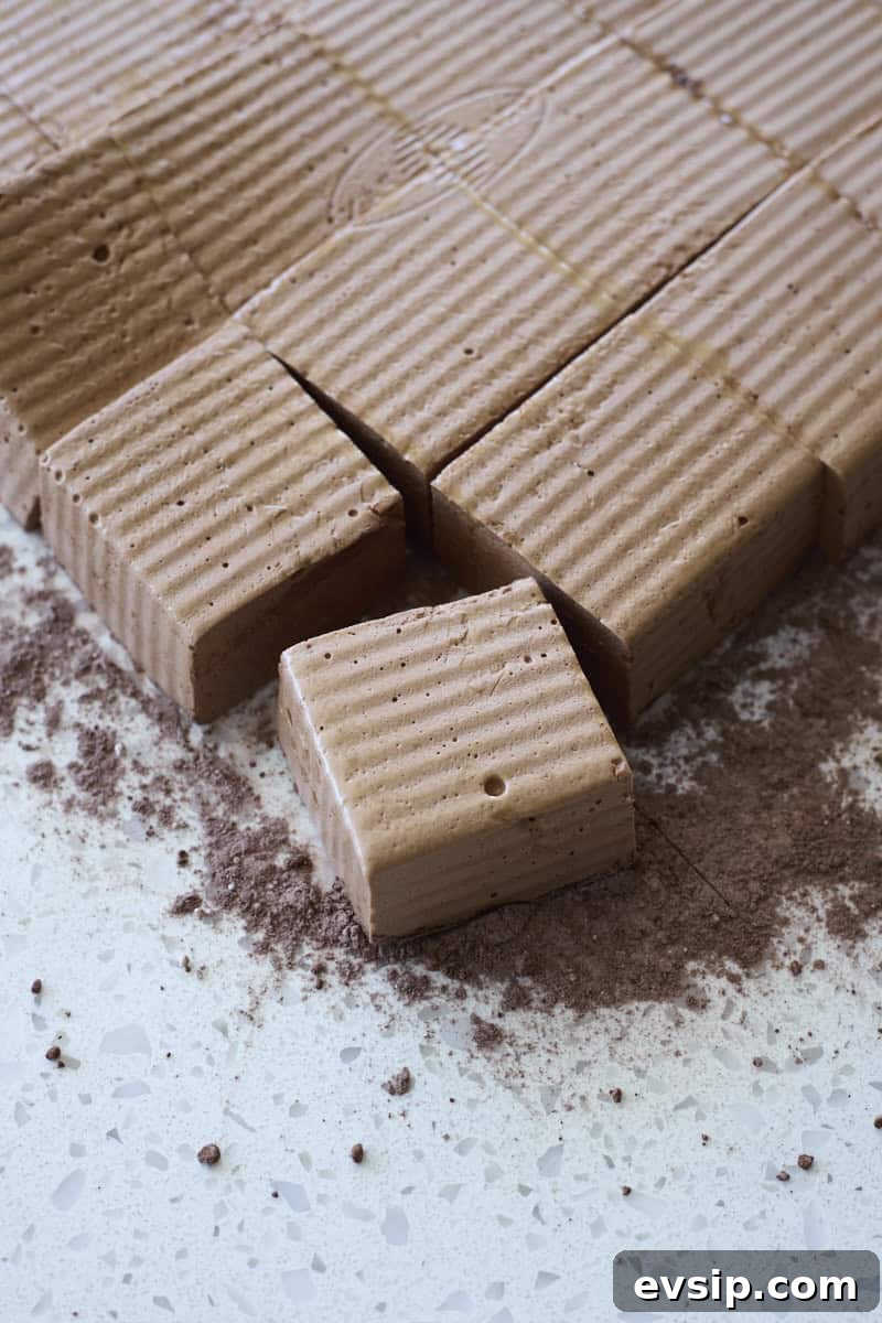 Chocolate Marshmallows Recipe: Homemade Gooey Chocolate Mallows 9 Sliced marshmallows on a work surface.