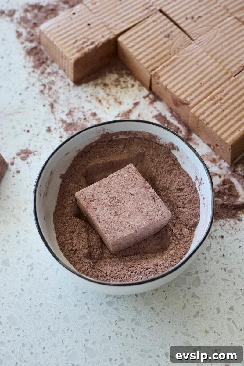 Chocolate Marshmallows Recipe: Homemade Gooey Chocolate Mallows 10 Marshmallow being rolled in the powdered sugar mixture.
