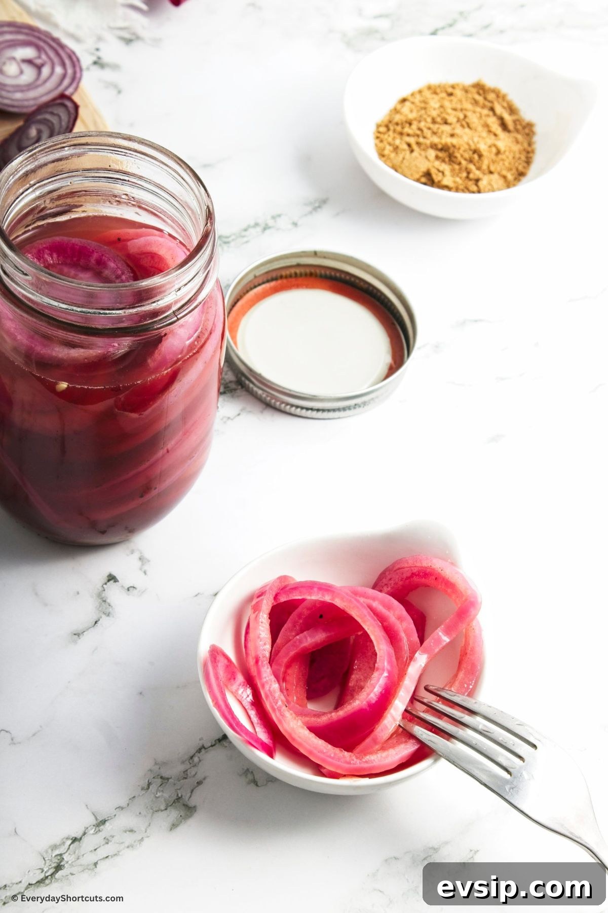 Tangy Quick-Pickled Red Onions for Salads and Sandwiches 3 pickled red onions in a mason jar