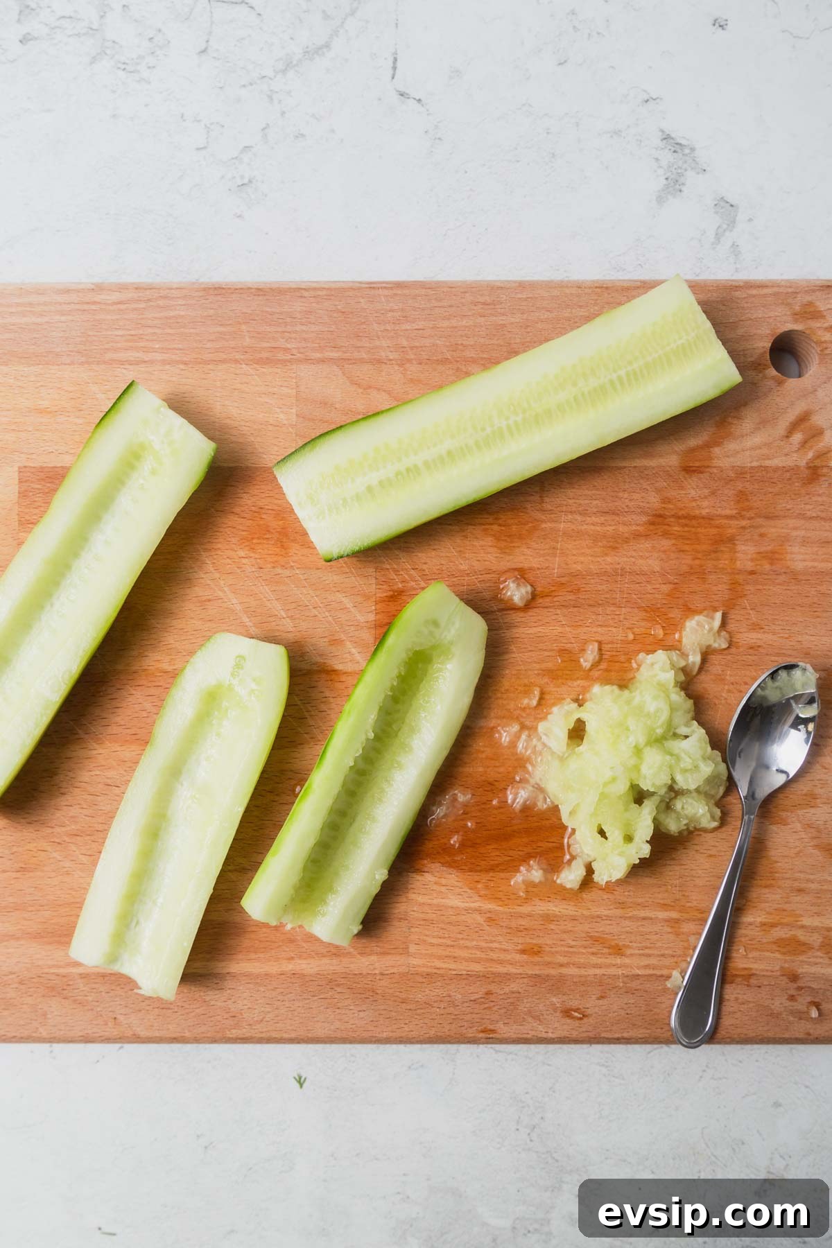 removing the seeds from the peeled cucumbers.
