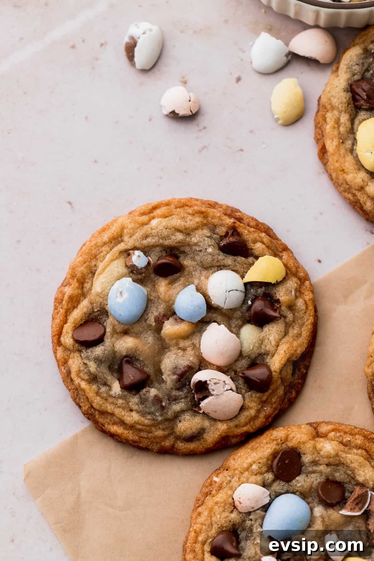 Bite-Sized Mini Egg Cookies with Chocolate Candy Centers 8 One mini egg cookie on parchment paper.