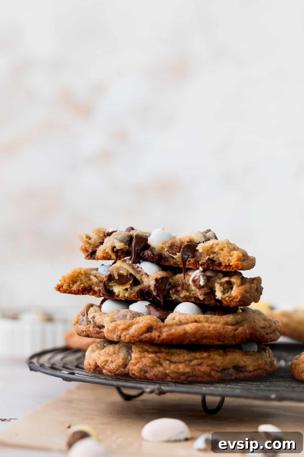 Bite-Sized Mini Egg Cookies with Chocolate Candy Centers 9 Stack of cookies of a wire rack.