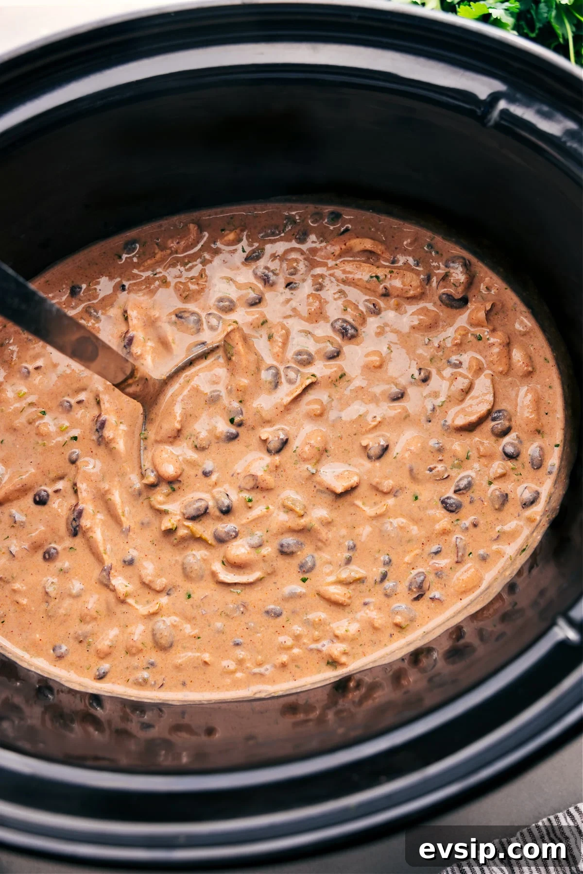 Green Chile Chicken Enchilada Soup with Fresh Herbs and Avocado Green Chicken Enchilada Soup in the crockpot, ready to serve.