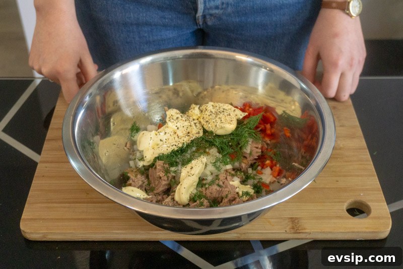Adding all the tuna salad ingredients into a mixing bowl