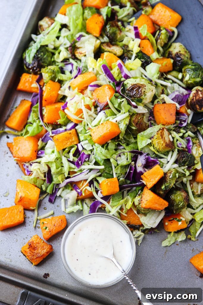 Roasted Garlic Vegetable Salad with Balsamic Vinaigrette 5 Mixed greens and roasted vegetables mixed on a sheet pan with a bowl of dressing