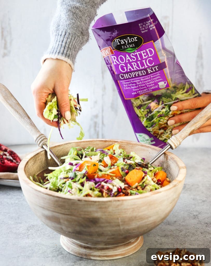 Roasted Garlic Vegetable Salad with Balsamic Vinaigrette 7 Sprinkling mixed greens in a large bowl with roasted vegetables and other ingredients for the salad