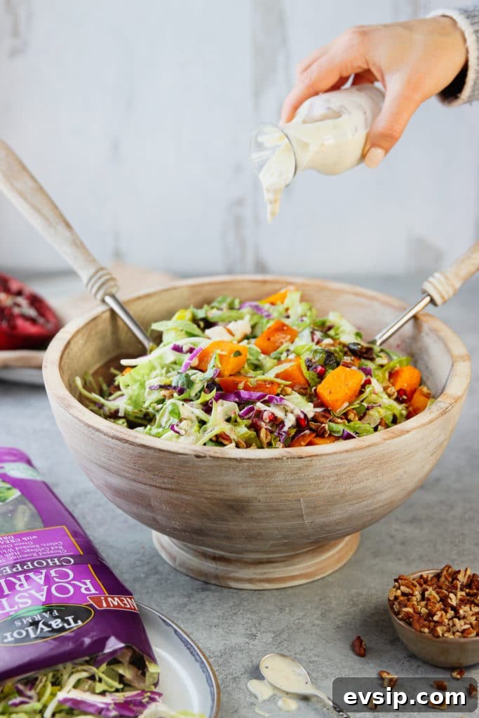 Roasted Garlic Vegetable Salad with Balsamic Vinaigrette 8 Salad dressing from a glass container poured on a bowl for tossing