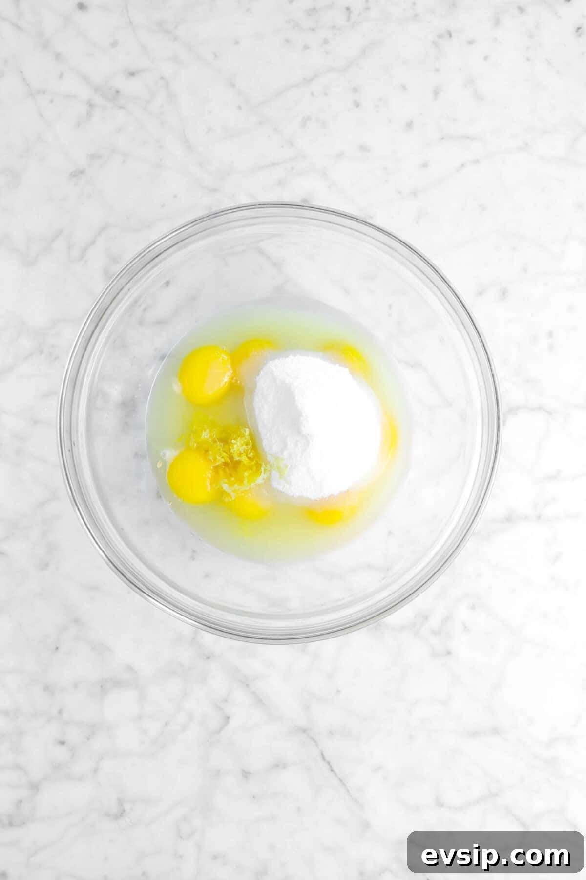 eggs, lemon juice, lemon zest, and sugar in glass bowl