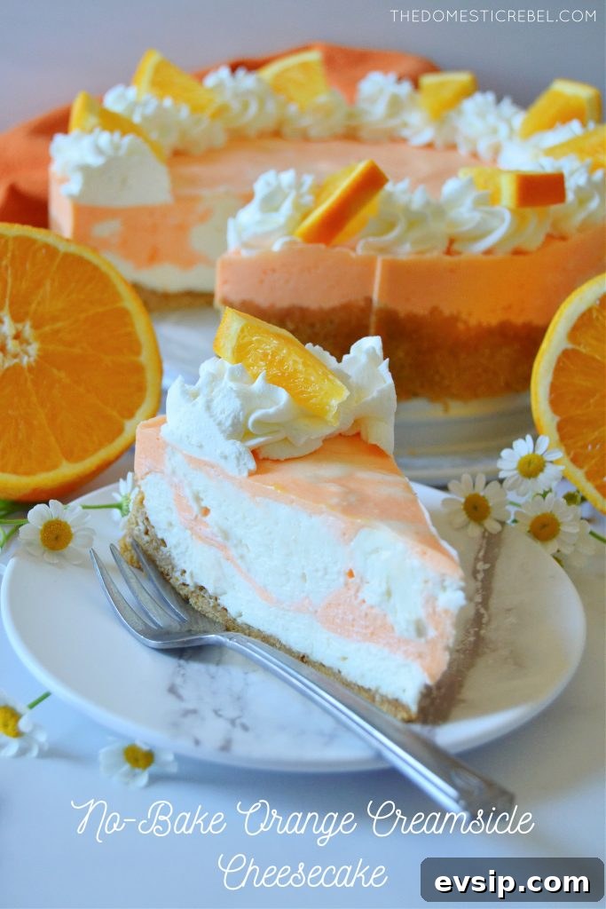 No-Bake Orange Creamsicle Cheesecake Recipe 2 orange creamsicle cheesecake on a white plate with a fork