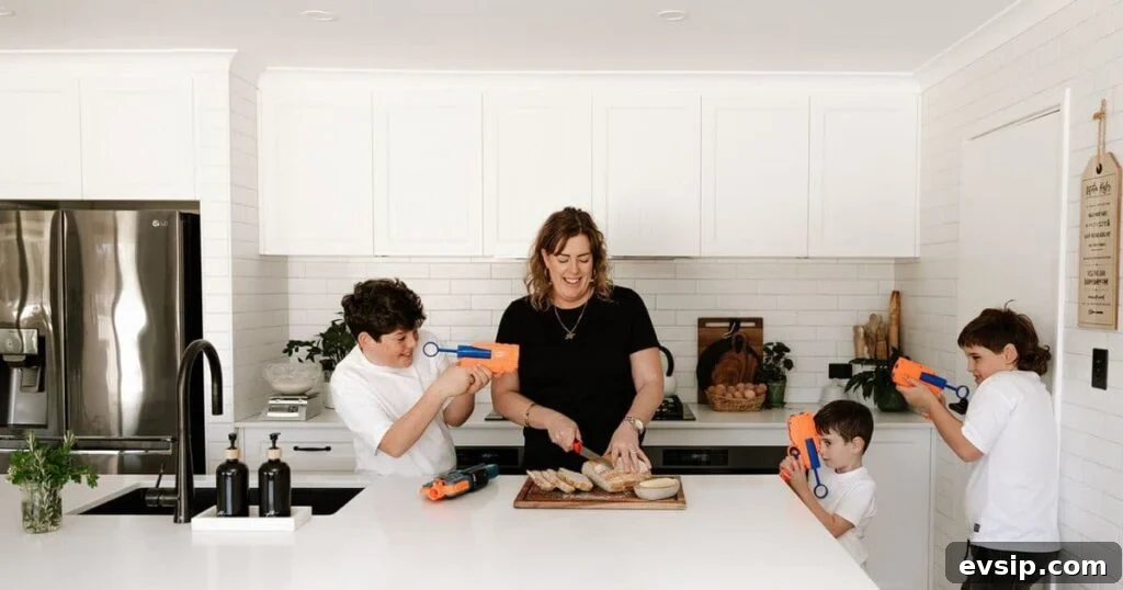 20 Sourdough Discard Recipes Perfect for Freezing 2 A mum in the kitchen slicing up a loaf of sourdough bread while kids play with Nerf blasters around her.