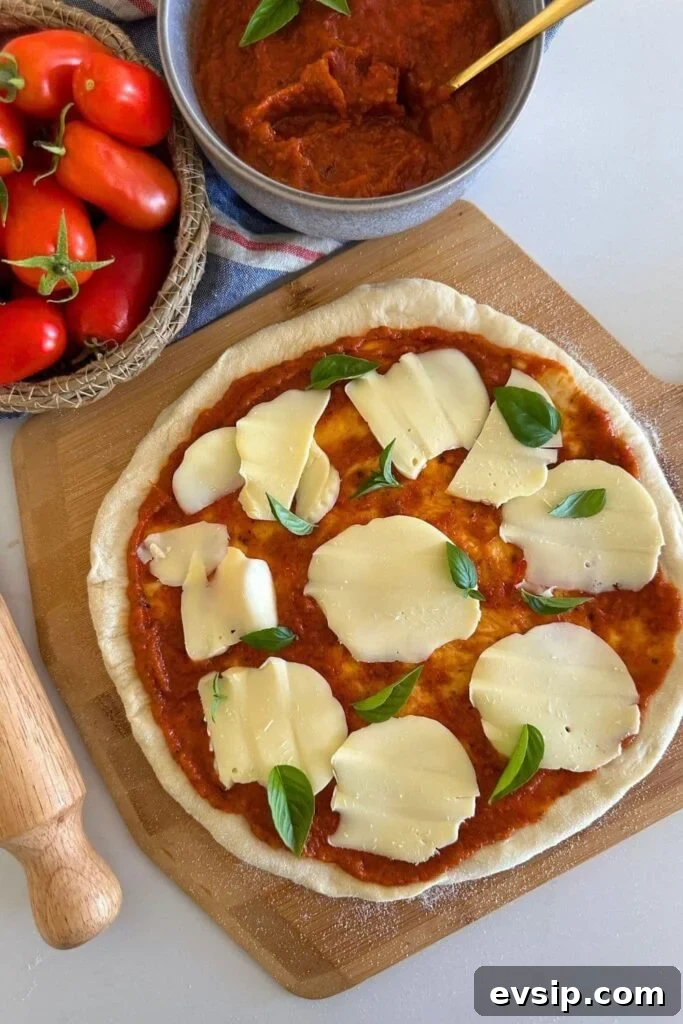 20 Sourdough Discard Recipes Perfect for Freezing 12 A sourdough pizza base topped with tomato pizza sauce, mozzarella cheese and basil.